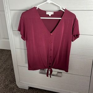 Woman’s deep magenta button up blouse
